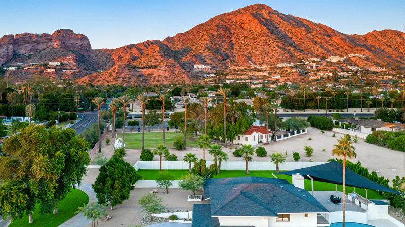 Aerial view of a residential area with mountains in the background